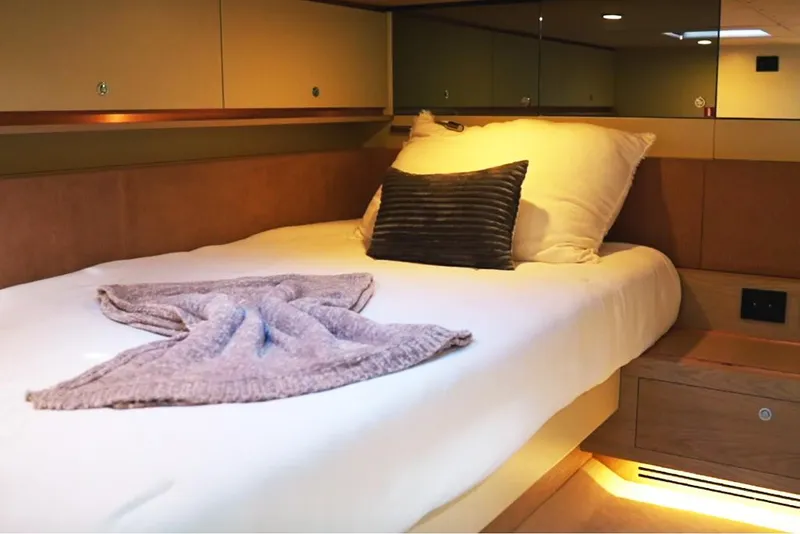 Slide: The Image of Luxurious cabin interior of 2025 Waterdream California 52XT yacht with cozy bed and soft lighting. - 21