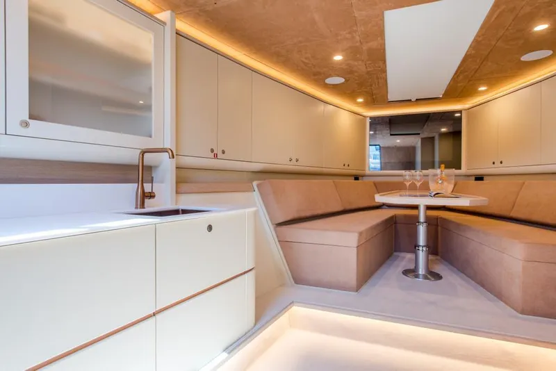 Slide: The Image of Luxurious interior of 2025 Waterdream California 52XT yacht with modern seating and kitchenette. - 23