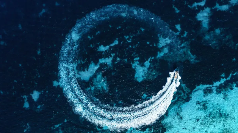 Slide: The Image of Aerial view of Waterdream California 52XT boat creating a circular wake in deep blue ocean, 2025. - 4