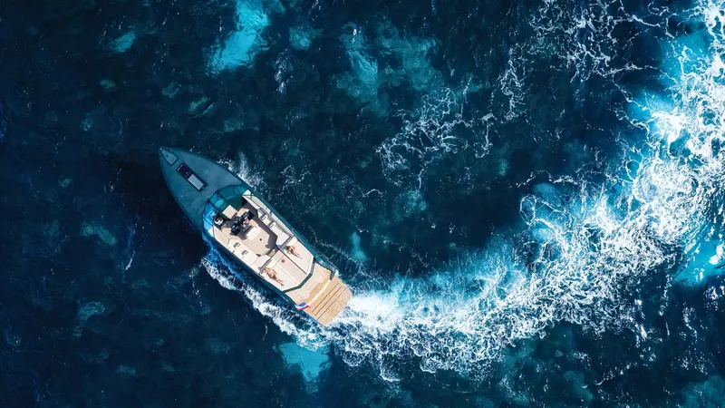 Slide: The Image of Aerial view of 2025 Waterdream California 52XT yacht cruising through vibrant blue ocean waters. - 5