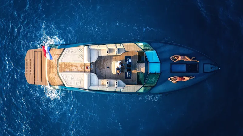Slide: The Image of Aerial view of 2025 Waterdream California 52XT yacht cruising on blue ocean waters. - 9