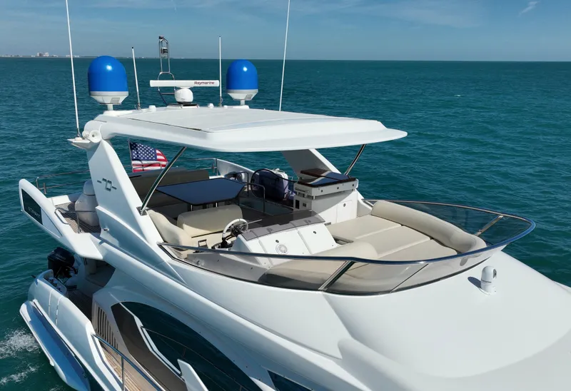 Slide: The Image of Luxury 2014 Azimut 70 yacht cruising on open sea with clear blue sky. - 13