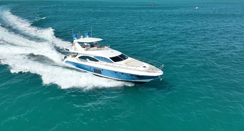 Slide: The Image of Luxurious 2014 Azimut 70 yacht cruising on clear blue ocean waters. - 15