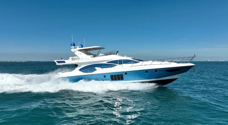 Slide: The Image of 2014 Azimut 70 yacht cruising on open water under clear blue skies. - 17