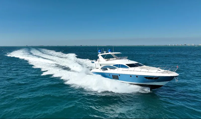 Slide: The Image of Luxury 2014 Azimut 70 yacht cruising on open sea under clear blue sky. - 19