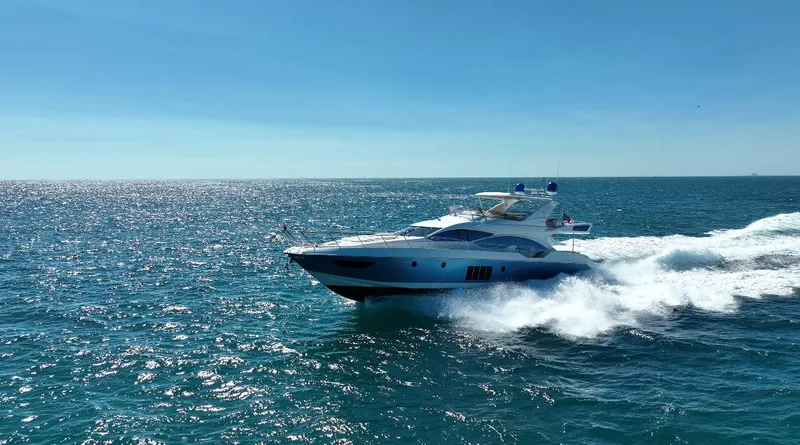 Slide: The Image of Azimut 70 yacht cruising on open sea, 2014 model, under clear blue sky. - 20