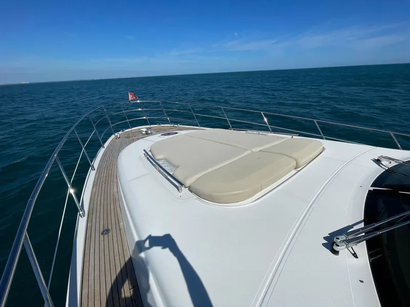 Slide: The Image of 2014 Azimut 70 yacht deck with sunbed, cruising on open sea under clear blue sky. - 22