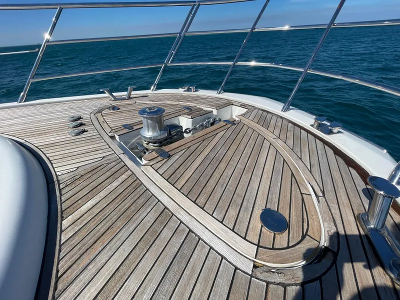 Slide: The Image of 2014 Azimut 70 yacht deck with wooden finish, cruising on open water. - 23