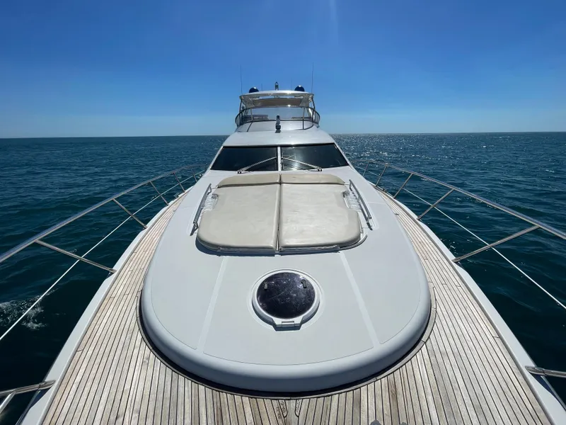 Slide: The Image of 2014 Azimut 70 yacht cruising on open sea under clear blue sky. - 24