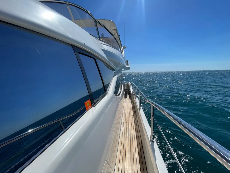 Slide: The Image of 2014 Azimut 70 yacht cruising on open sea under clear blue sky. - 25
