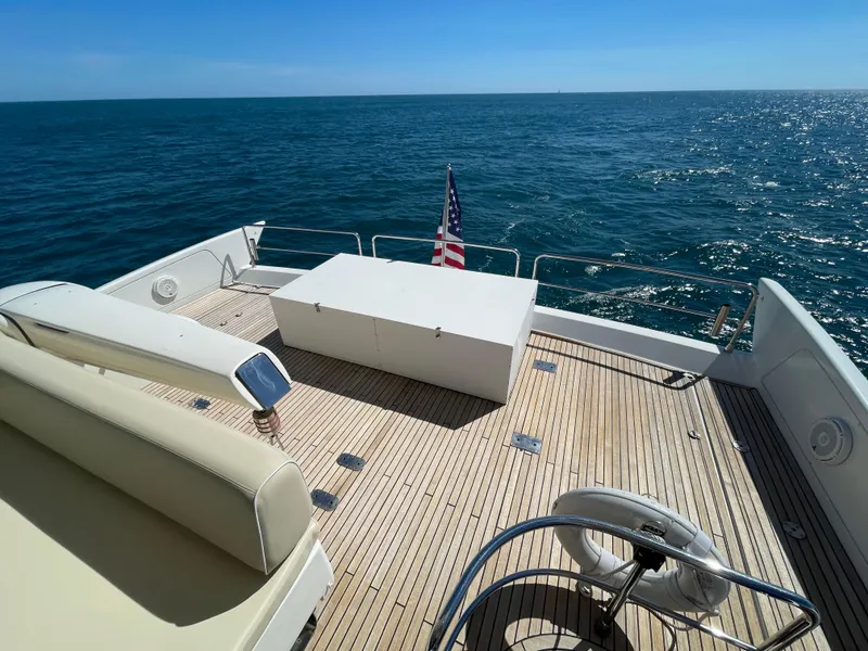 Slide: The Image of 2014 Azimut 70 yacht deck with seating, ocean view, and American flag. - 34