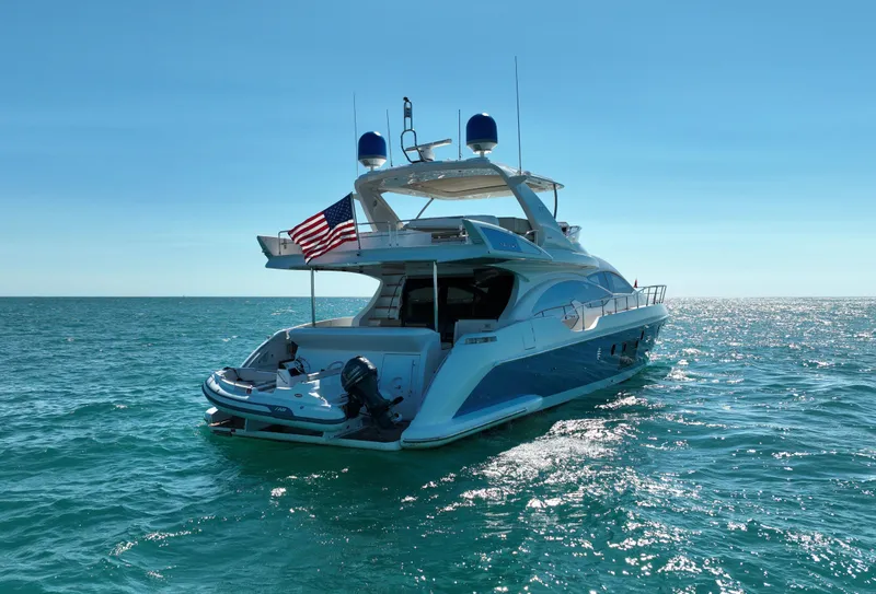 Slide: The Image of 2014 Azimut 70 yacht on open water, featuring sleek design and American flag. - 5