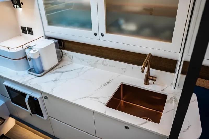 Slide: The Image of Modern kitchen in 2025 Waterdream California 52XT yacht with marble countertop and copper sink. - 12