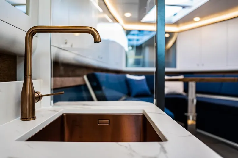 Slide: The Image of Luxurious interior of 2025 Waterdream California 52XT Hardtop yacht with modern sink and seating area. - 13