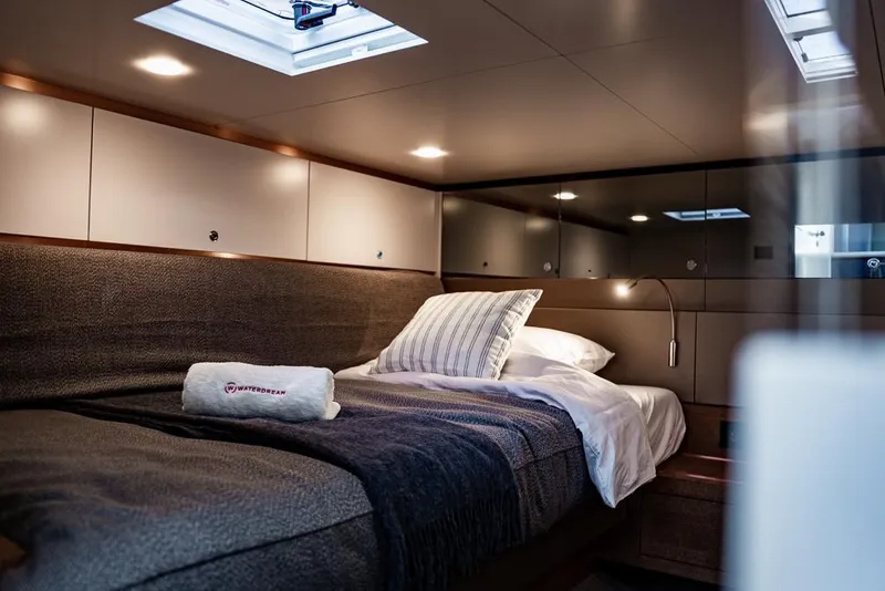 Slide: The Image of Luxurious cabin interior of 2025 Waterdream California 52XT Hardtop yacht, featuring cozy bedding and modern lighting. - 19