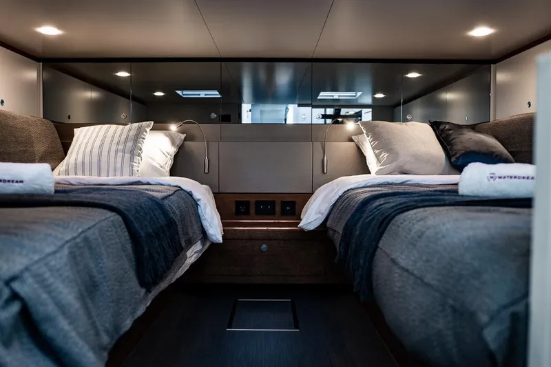 Slide: The Image of Luxurious cabin interior of 2025 Waterdream California 52XT Hardtop with twin beds and modern decor. - 20