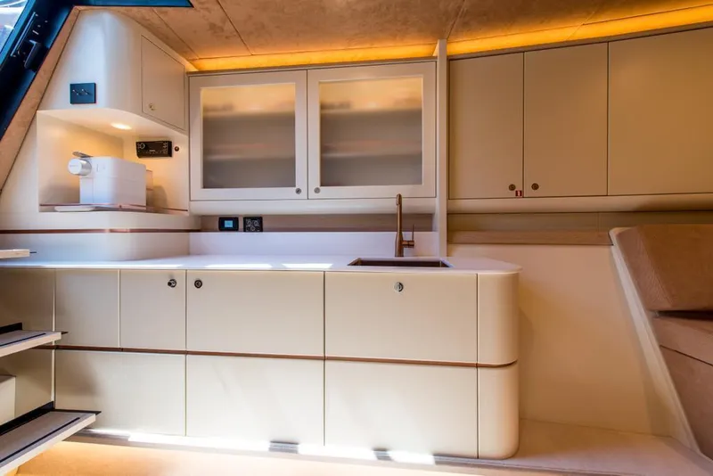 Slide: The Image of Modern kitchen interior of 2025 Waterdream California 52XT Hardtop yacht, featuring sleek cabinetry and lighting. - 8