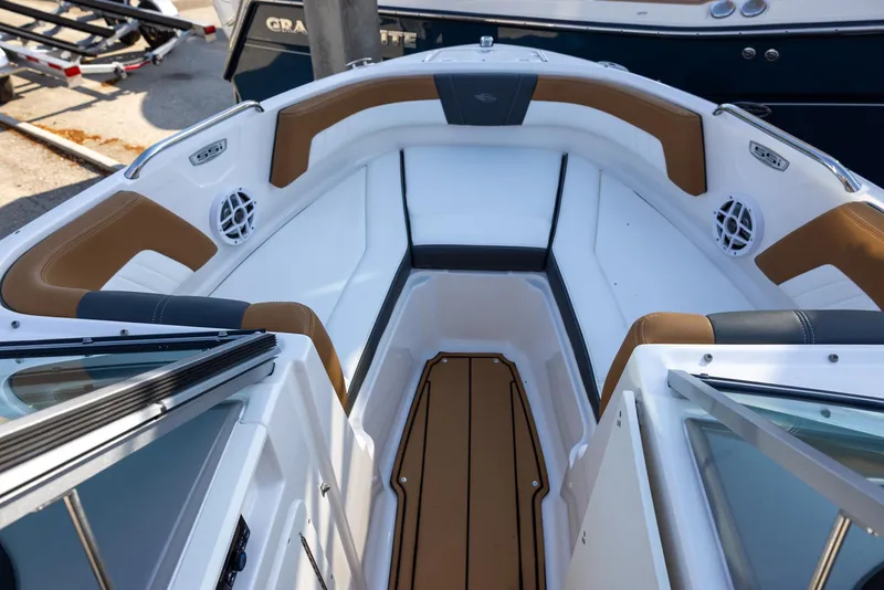 Slide: The Image of 2023 Chaparral 21 SSi OB boat interior with brown and white seating. - 10