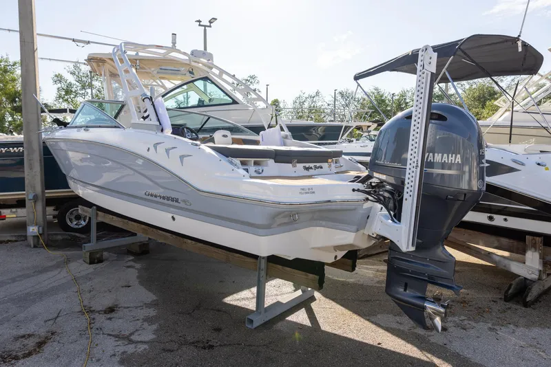 Slide: The Image of 2023 Chaparral 21 SSi OB boat with Yamaha outboard motor, displayed outdoors. - 2