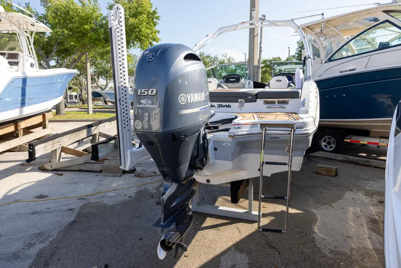Slide: The Image of 2023 Chaparral 21 SSi OB boat with Yamaha 150 outboard motor, docked outdoors. - 3