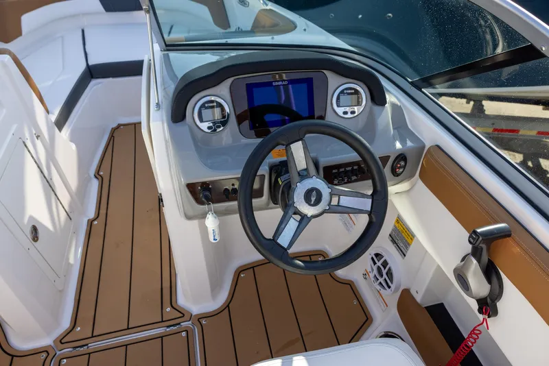 Slide: The Image of 2023 Chaparral 21 SSi OB boat dashboard with steering wheel and modern controls. - 4
