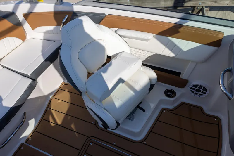 Slide: The Image of 2023 Chaparral 21 SSi OB boat interior with white seating and brown accents. - 5