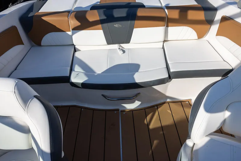 Slide: The Image of 2023 Chaparral 21 SSi OB boat interior with white and brown seating. - 7