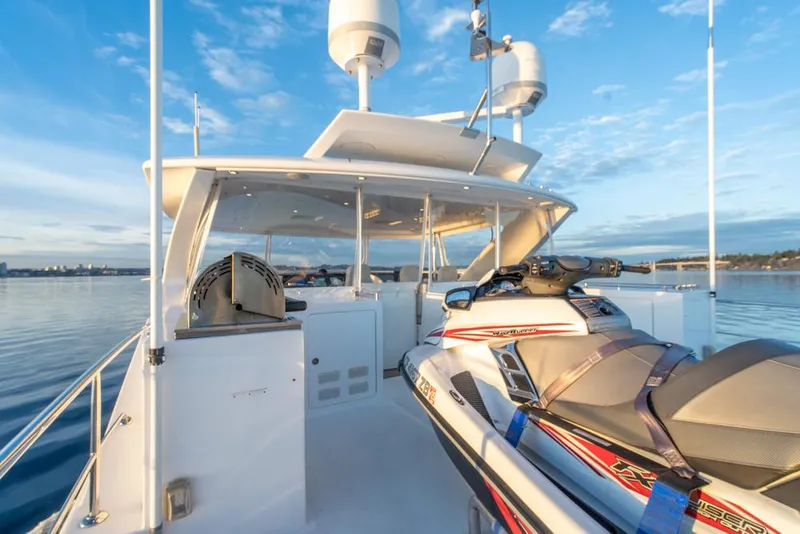 Slide: The Image of Ocean Alexander 80' Motoryacht 2010 with jet ski on deck, under clear blue sky. - 17