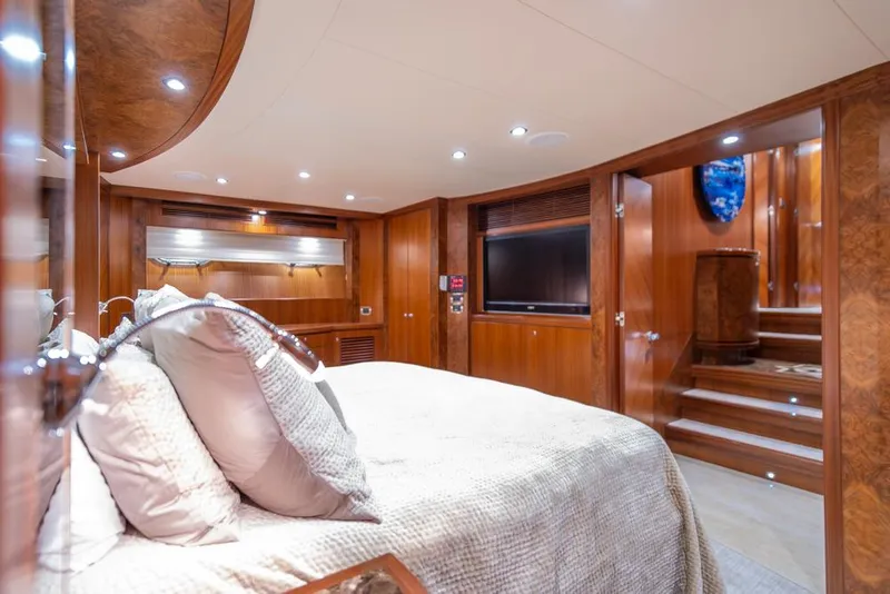 Slide: The Image of Luxurious bedroom interior of 2010 Ocean Alexander 80' Motoryacht with wood paneling and plush bedding. - 33