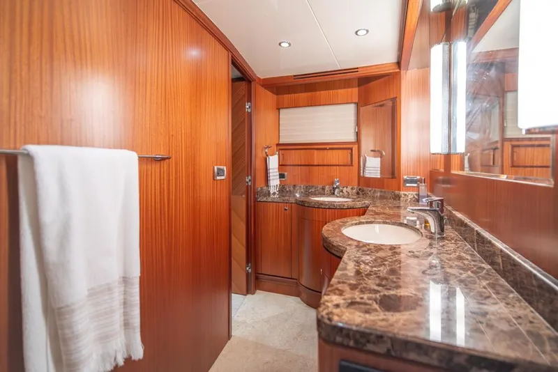 Slide: The Image of Luxurious bathroom in 2010 Ocean Alexander 80' Motoryacht with marble countertop and wood paneling. - 34