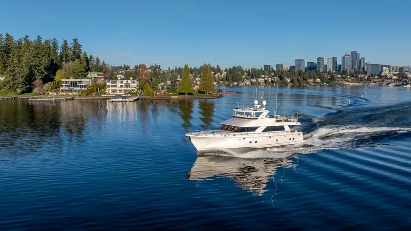 Slide: The Image of Luxurious 2010 Ocean Alexander 80' Motoryacht cruising on a serene lake with city skyline. - 4