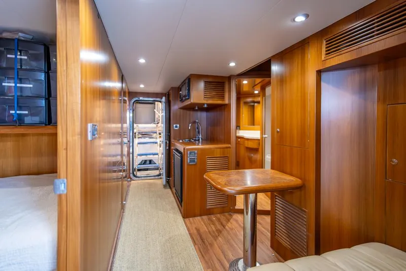 Slide: The Image of Luxurious interior of 2010 Ocean Alexander 80' Motoryacht with wood paneling and kitchenette. - 42