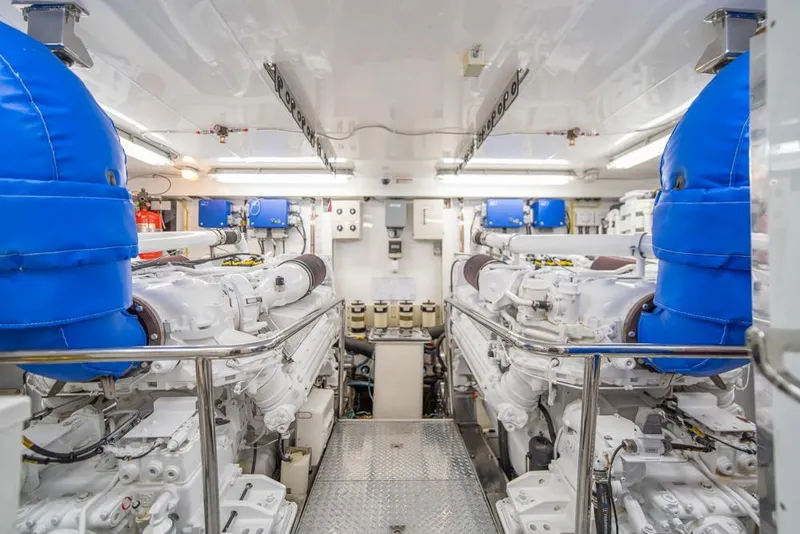 Slide: The Image of Engine room of 2010 Ocean Alexander 80' Motoryacht with dual engines and blue covers. - 45