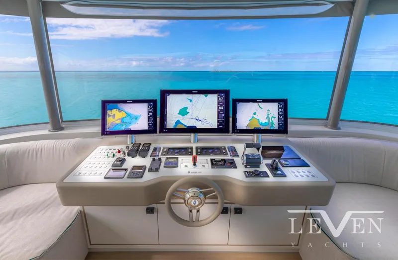 Slide: The Image of Helm of 2026 Van der Valk LeVen 90 yacht with navigation screens and ocean view. - 12