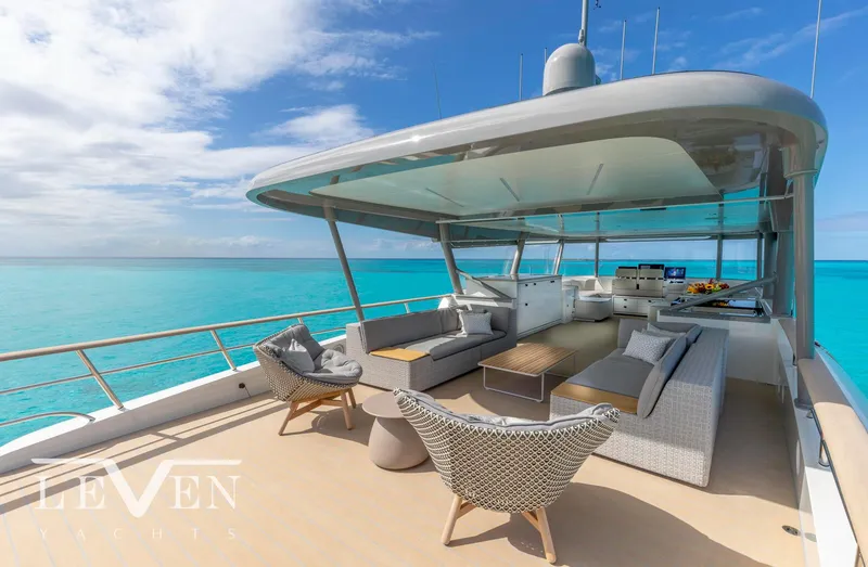 Slide: The Image of Luxurious Van der Valk LeVen 90 yacht deck with modern seating, overlooking turquoise ocean, 2026 model. - 9