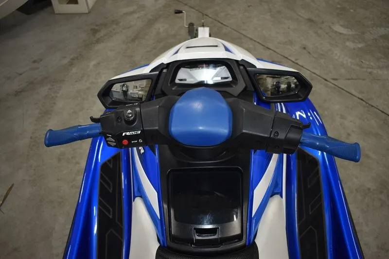 Slide: The Image of 2017 Yamaha WaveRunner GP1800 handlebars and dashboard, blue and white design, in a garage setting. - 12