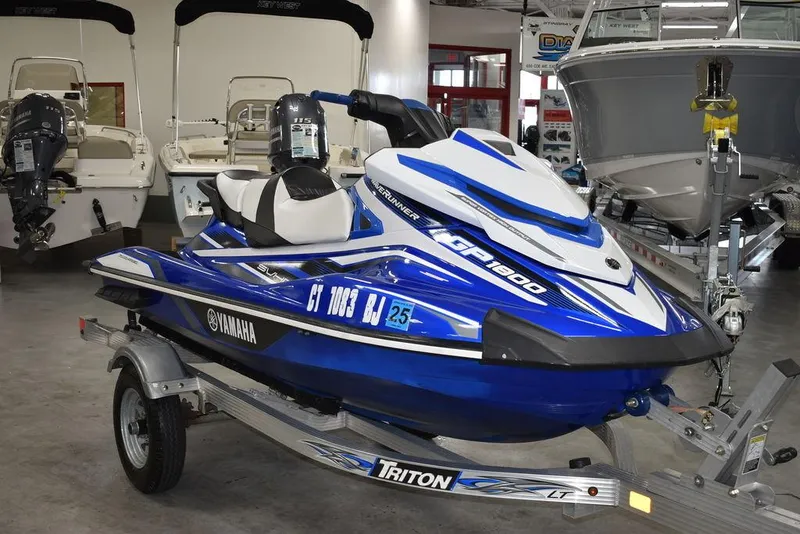Slide: The Image of 2017 Yamaha WaveRunner GP1800 in showroom, blue and white, on Triton trailer. - 4