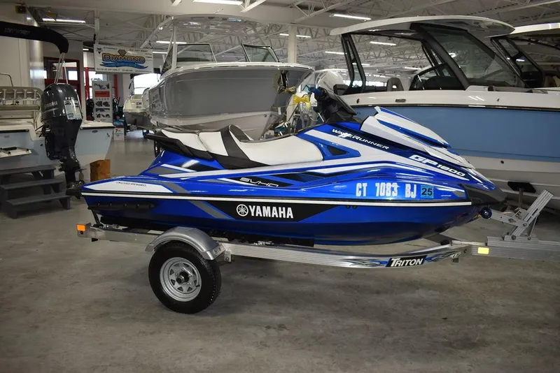 Slide: The Image of 2017 Yamaha WaveRunner GP1800 on trailer in showroom, blue and white design. - 5