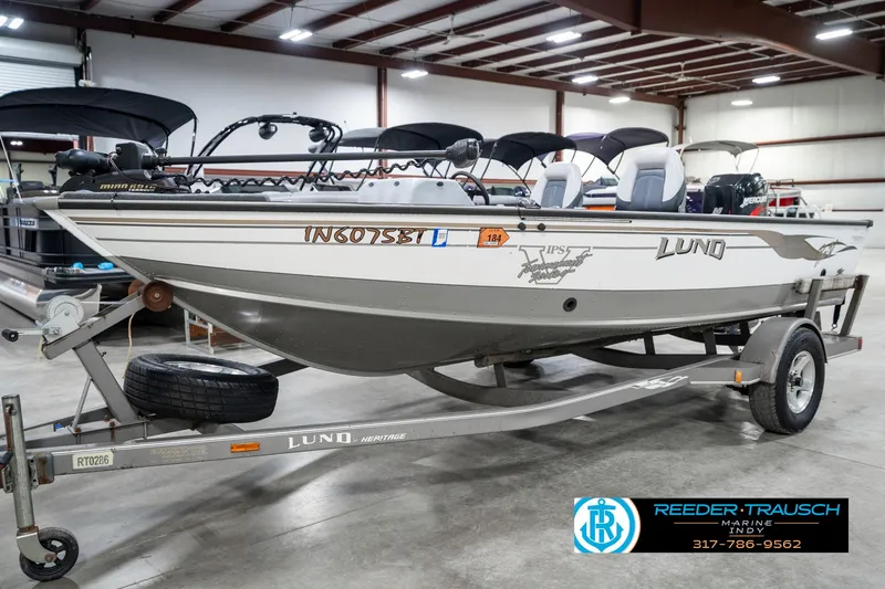 Slide: The Image of 2001 Lund 1775 Pro V SE fishing boat on trailer in showroom. - 2