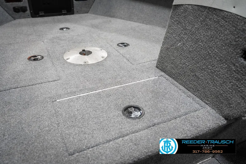 Slide: The Image of 2001 Lund 1775 Pro V SE boat interior with carpeted flooring and storage compartments. - 25