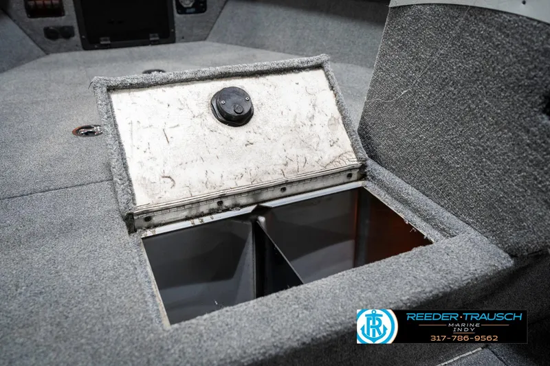Slide: The Image of 2001 Lund 1775 Pro V SE boat storage compartment with open lid, carpeted interior. - 26