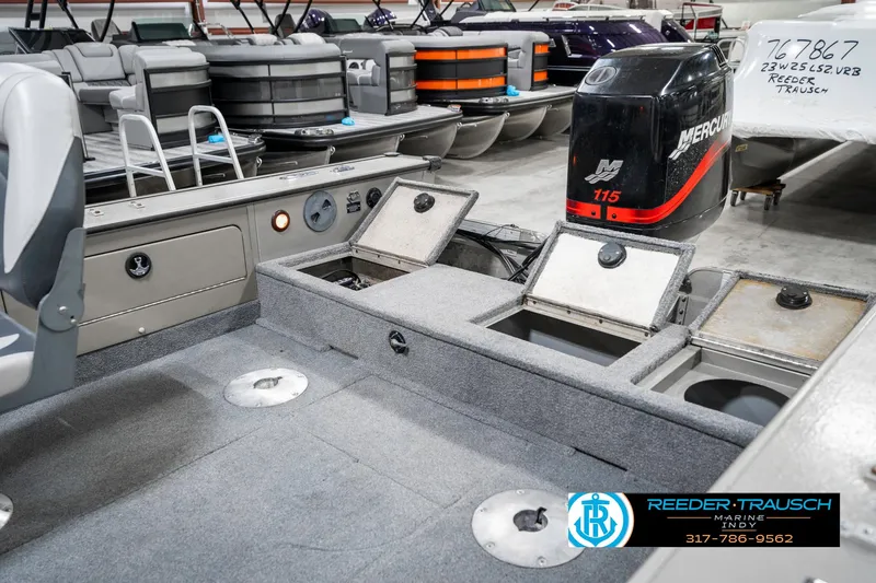 Slide: The Image of 2001 Lund 1775 Pro V SE boat interior with storage compartments and Mercury 115 outboard motor. - 34