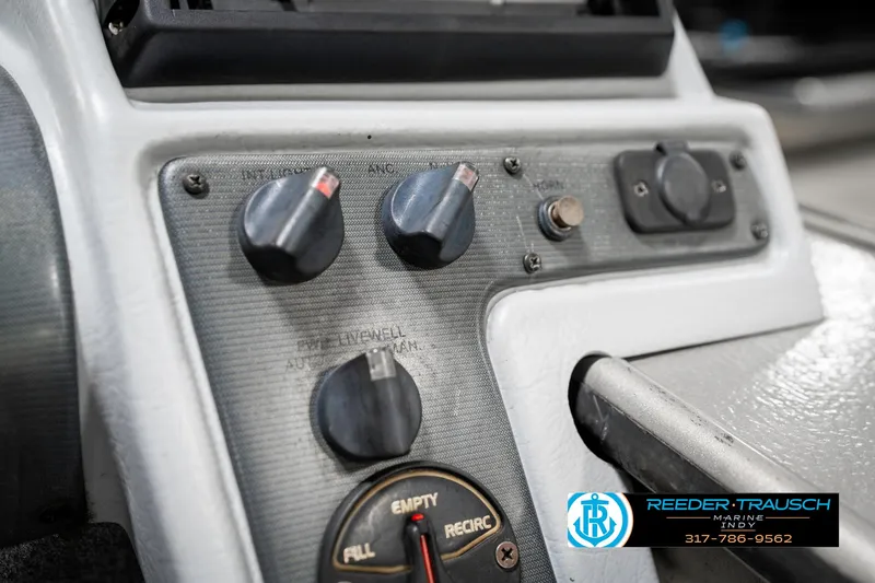 Slide: The Image of Control panel of a 2001 Lund 1775 Pro V SE boat with various knobs and switches. - 41