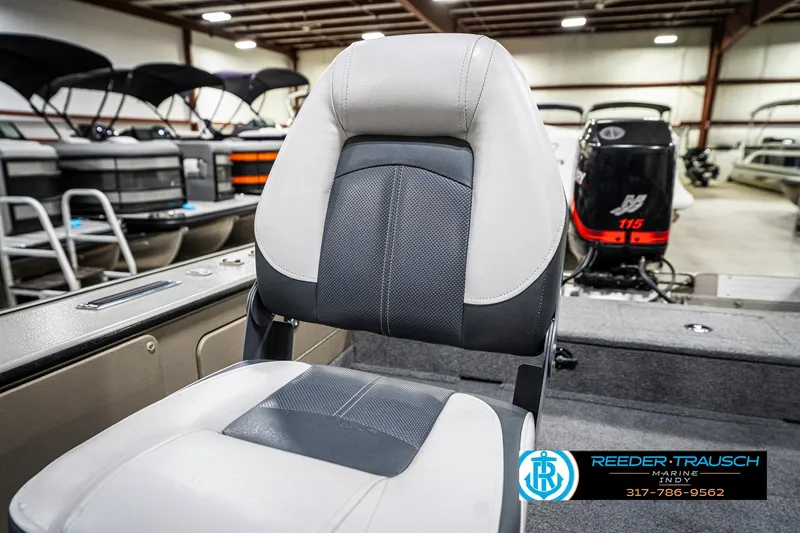 Slide: The Image of 2001 Lund 1775 Pro V SE boat interior with seating and motor, displayed in a showroom. - 43