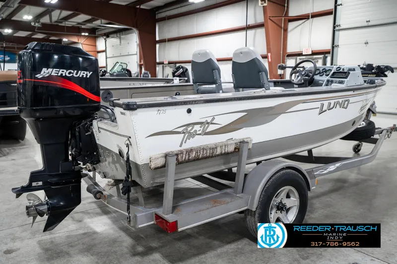 Slide: The Image of 2001 Lund 1775 Pro V SE boat with Mercury engine on trailer in indoor storage. - 6