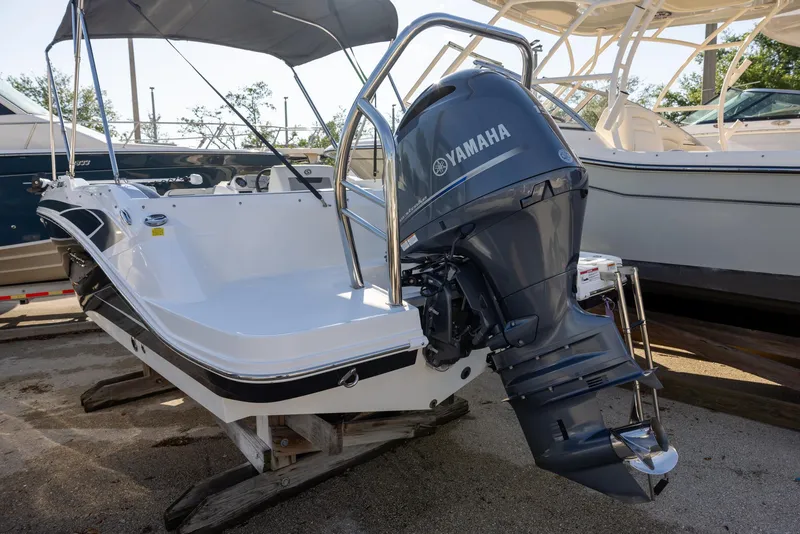 Slide: The Image of 2022 Hurricane SunDeck Sport 205 OB boat with Yamaha outboard motor, docked on a trailer. - 3