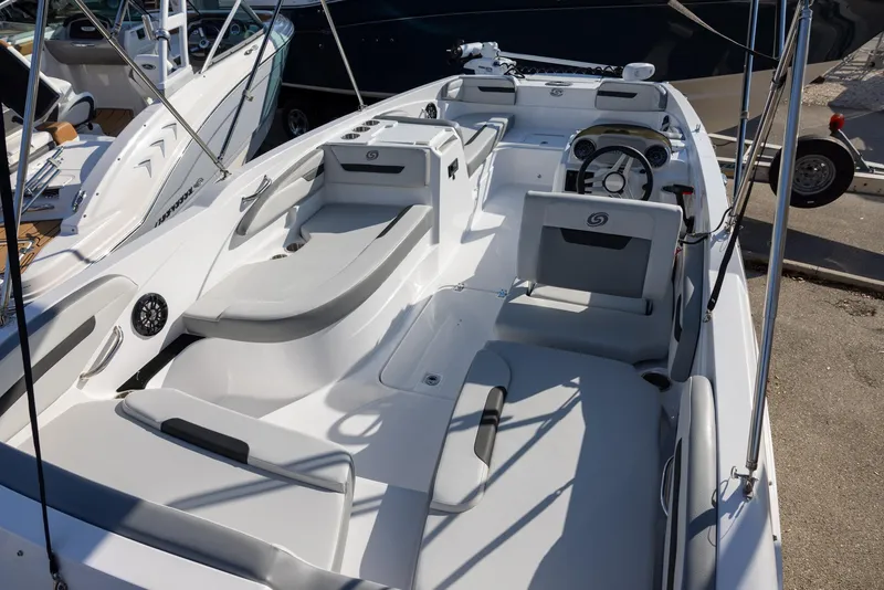 Slide: The Image of 2022 Hurricane SunDeck Sport 205 OB boat interior with seating and steering console. - 4