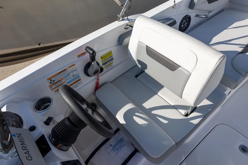 Slide: The Image of 2022 Hurricane SunDeck Sport 205 OB boat interior with steering wheel and white seating. - 6