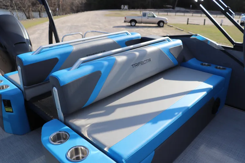 Slide: The Image of 2025 Trifecta 23 ULE boat interior with blue and gray seating, cup holders, and sleek design. - 12