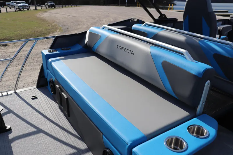 Slide: The Image of 2025 Trifecta 23 ULE boat interior with blue and gray seating, cup holders, and sleek design. - 13